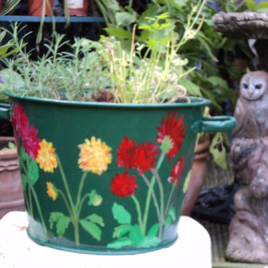 Painted large tub with Dahlia flowers now planted with herbs